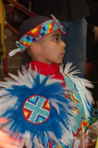 Native dancer looking on.