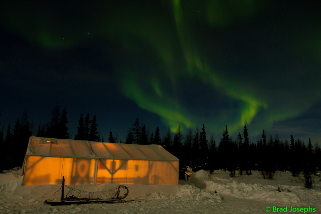 Churchill River mushing hut under the aurora.