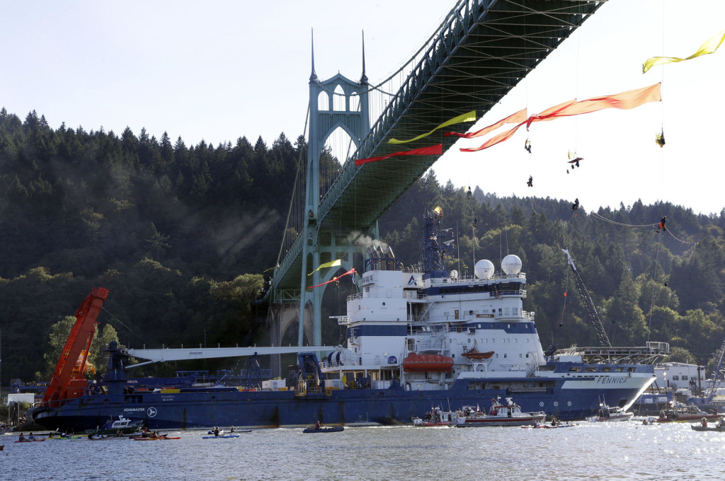The Royal Dutch Shell PLC icebreaker Fennica heads up the Willamette River under protesters hanging from the St. Johns Bridge on its' way to Alaska in Portland, Ore., Thursday, July 30, 2015. (AP Photo/Don Ryan) ORDR125 (Don Ryan / The Associated Press)