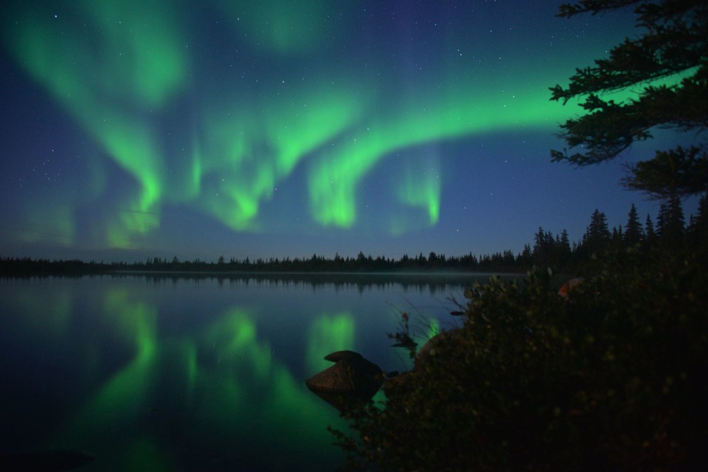 Swirling aurora borealis over a thermakarst in Churchill. Alex De Vries - Magnifico photo.