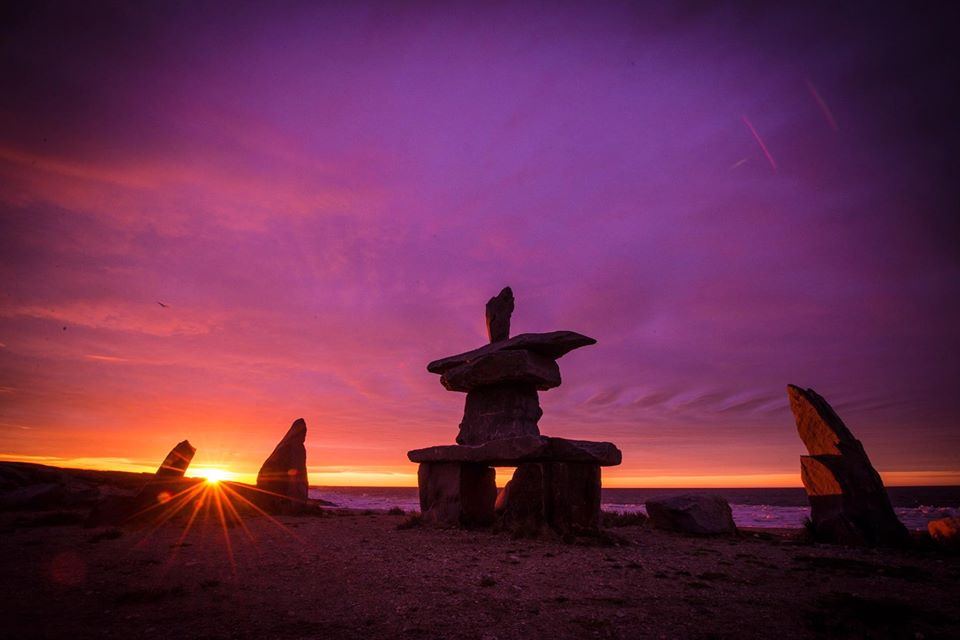 Inukshuk and sunset Churchill Manitoba